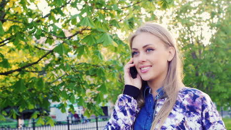 young woman walking in the park talking on the phone prores hq 422 10 bit