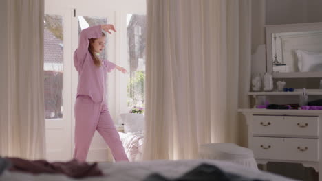 beautiful-young-woman-practicing-ballet-dancing-in-bedroom-rehearsing-dance-on-weekend-morning-wearing-pajamas