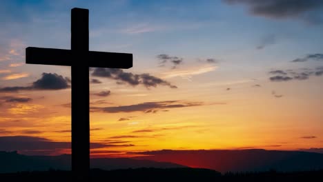 cross stands silhouetted against a stunning sunset sky, symbolizing faith and hope in a serene landscape