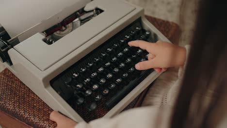 finger pressing a key on a vintage typewriter, evoking nostalgia and holiday warmth