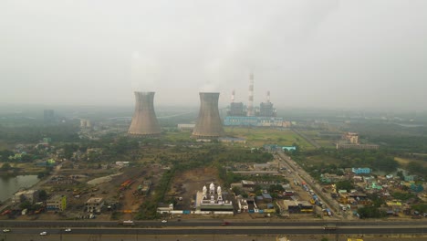 drone shot of industrial zones in india, with billowing smoke from chimneys dominating the skyline.