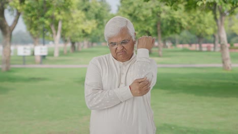 Sick-Indian-old-man-suffering-from-arthritis-in-park