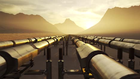 Five-streams-of-a-pipeline-with-heat-pipes-running-through-a-beautiful,-scenic,-foggy-desert-with-vast-mountains-in-the-background.-Fuel-travelling-through-a-pipe-system-supplying-petroleum.