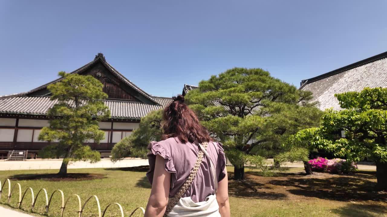 Woman walking inside Nijo Castle Japanese garden ground Ninomaru Palace