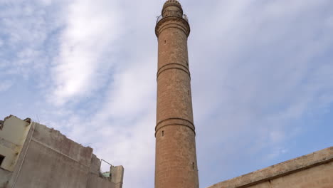 mardin's latifiye mosques minaret from bottom-up outside on a cloudy day