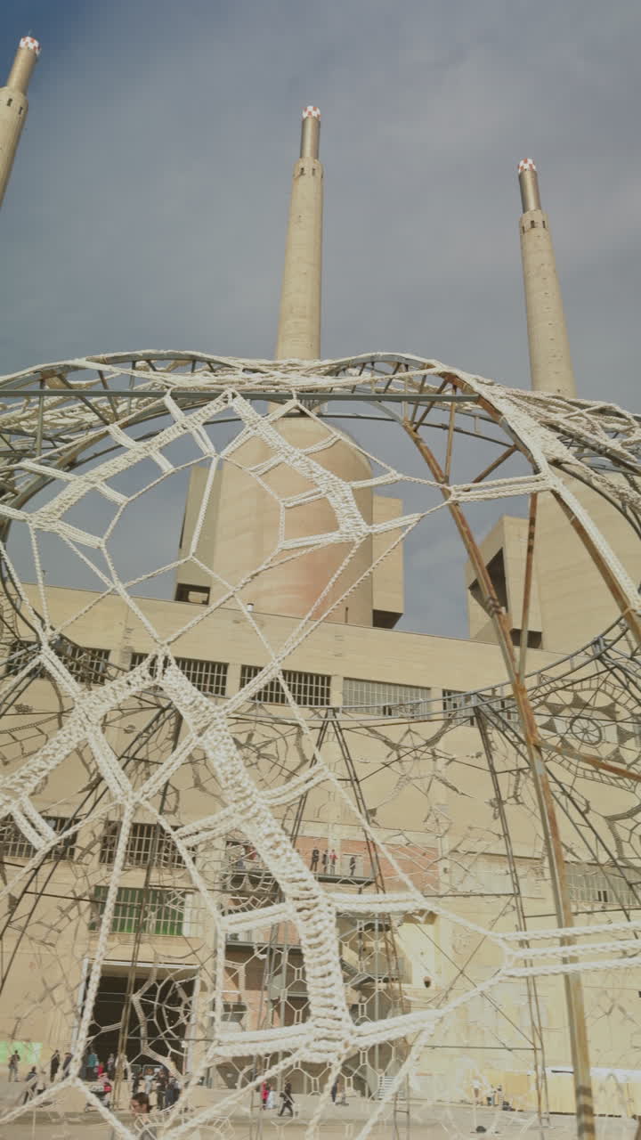 woven art pattern by the industrial towers in barcelona in vertical