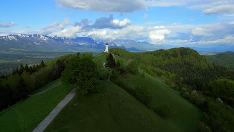 Jamnik-church-in-Slovenia-standing-on-a-hill-in-the-middle-of-spring-greenery