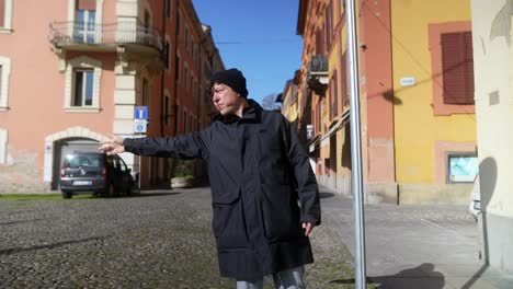 happy person raising arms in a city street