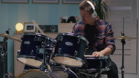 adult man playing drums in musical studio expressing emotions and feelings hobby and professional adult man playing drums in musical studio expressing emotions and feelings hobby and professional occupation backlit silhouette of male person performing rock gig on stage feel energy and power