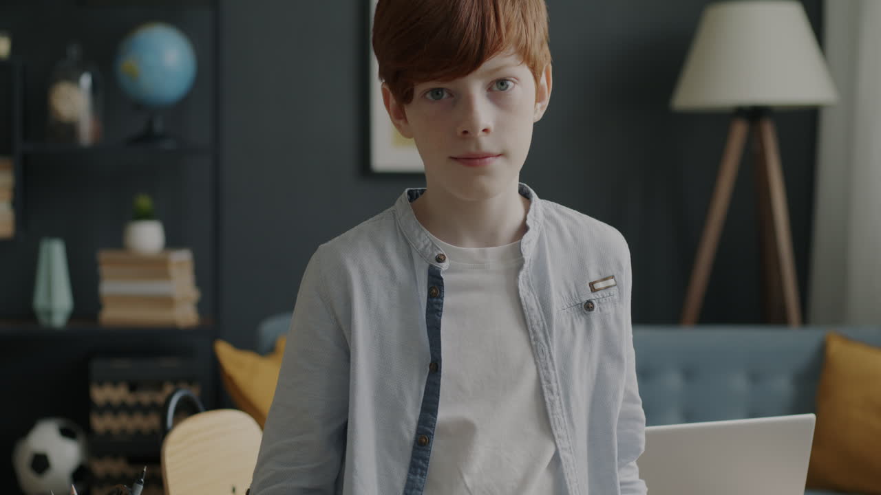 Boy waving hello to the camera