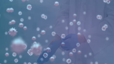 Animation-of-virus-cells-over-caucasian-doctor-wearing-gloves