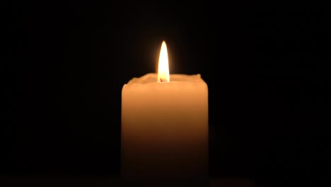 candle burning with dark background clouse up footage