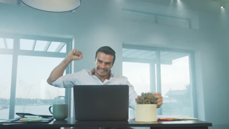 Caucasian man reading news on laptop in luxury house