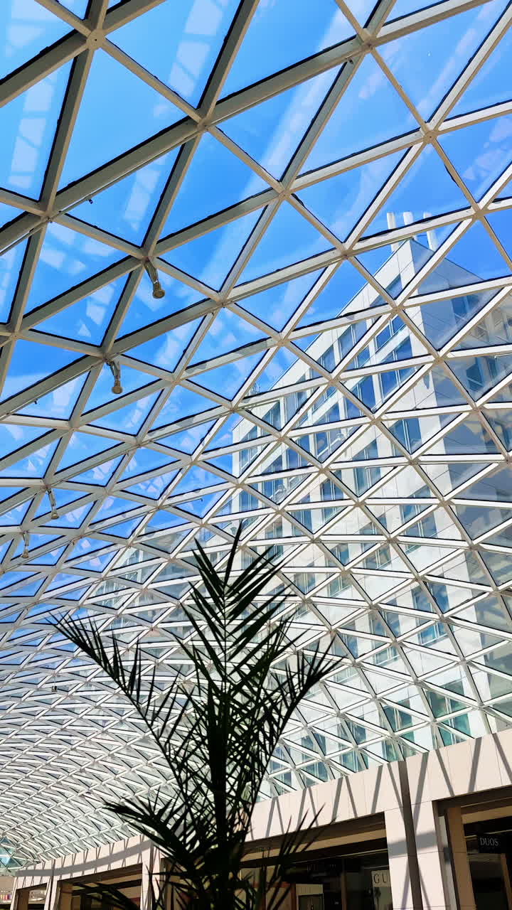 Modern design. A striking geometric structure with a glass and metal design allows sunlight to illuminate the space below