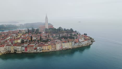 rovinj’s charming old town under an overcast sky, the calm adriatic sea, drone