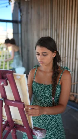 young woman painting outdoors