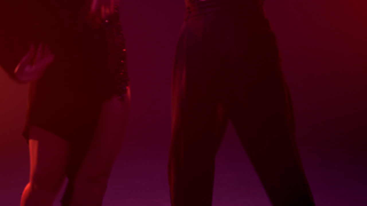 Unrecognizable dance couple performing on stage. Unknown ballroom pair dancing.