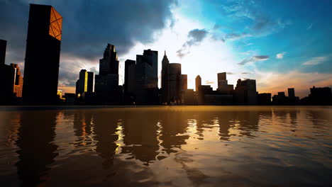 skyline with skyscrapers and sea at sunset