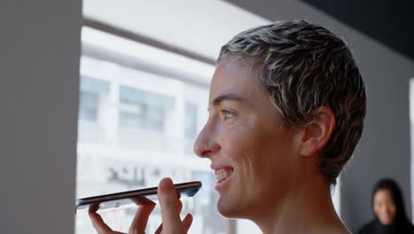 female executive talking on mobile phone in office 4k