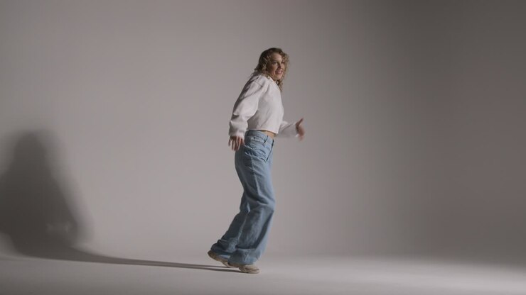 Full Length Studio Shot Of Young Woman Having Fun Dancing Against Grey Background 1