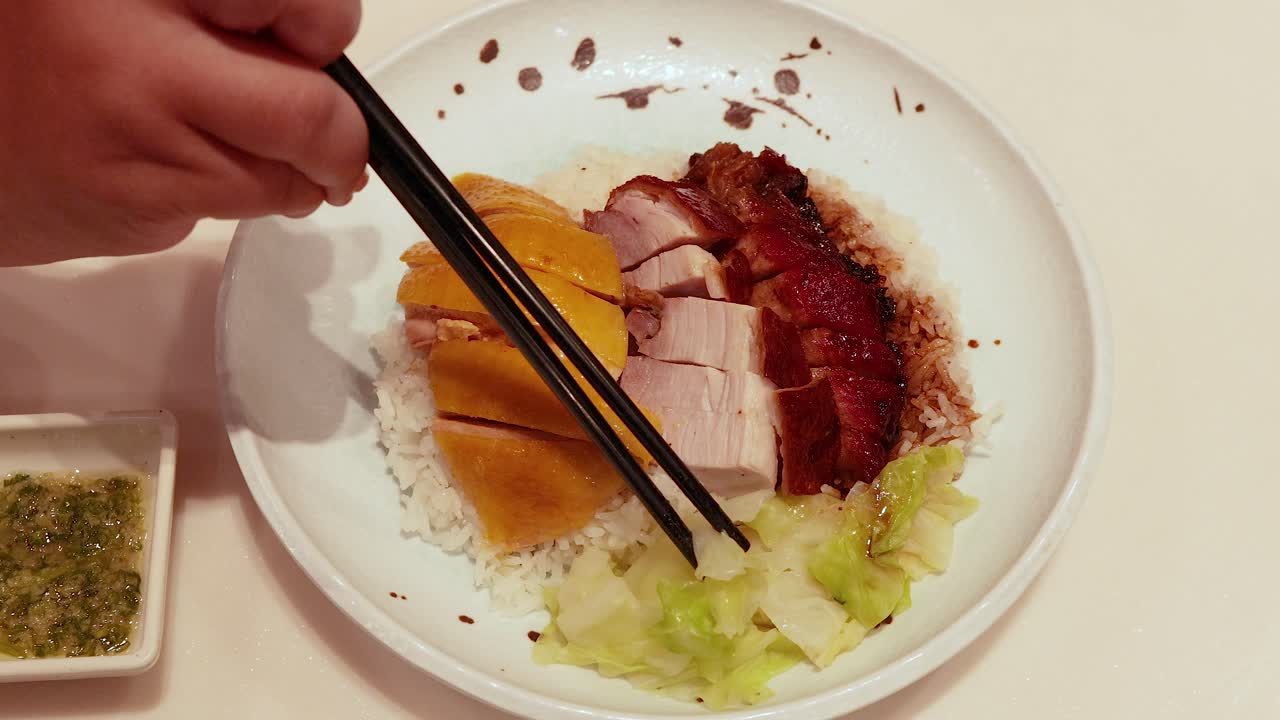 Chopsticks picking food from a plate