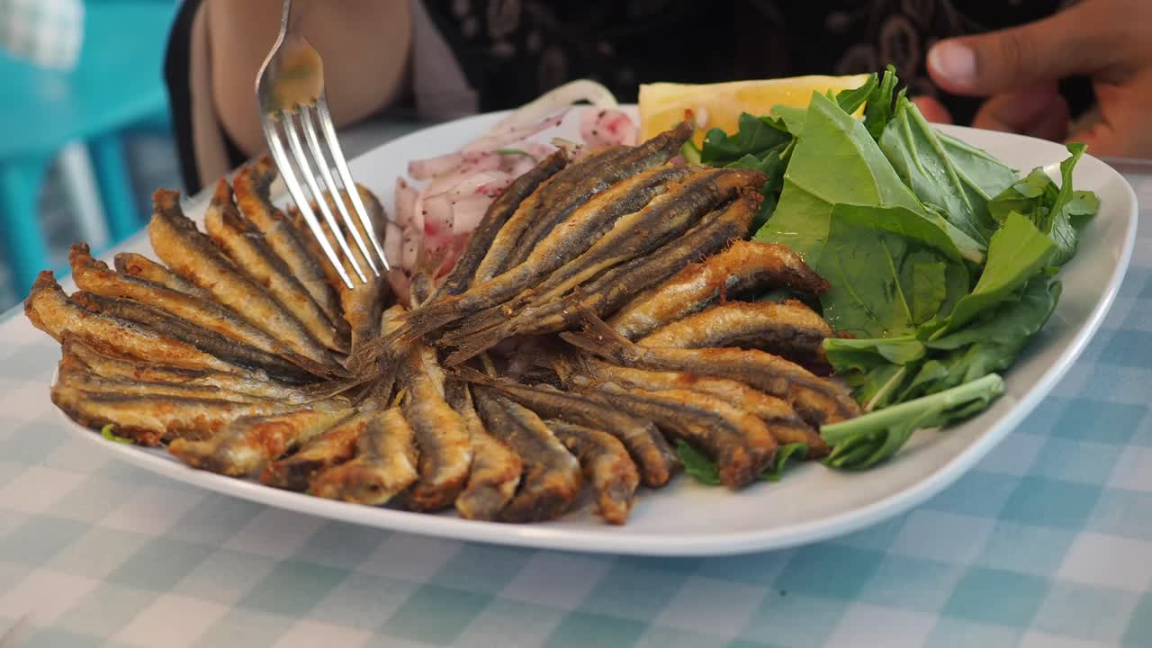 Plate of Fried Anchovies with Salad and Lemon