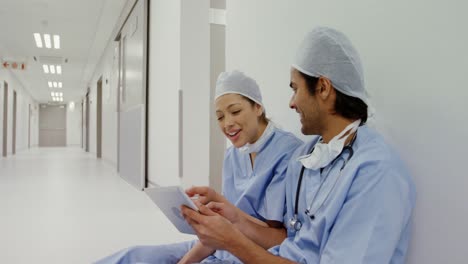 Surgeons-discussing-over-digital-tablet