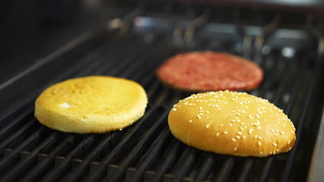 grilled burger cutlet beef minced meat patties. cooking beef and pork patty for burger. raw cutlet burger and two buns.