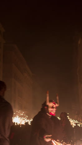 barcelona, spain - 22 september 2023 : crowds in the street for the fire run or correfoc, during la merce festival, barcelona spain in vertical