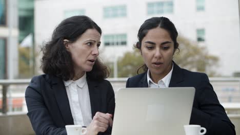 businesswomen using laptop in cafe