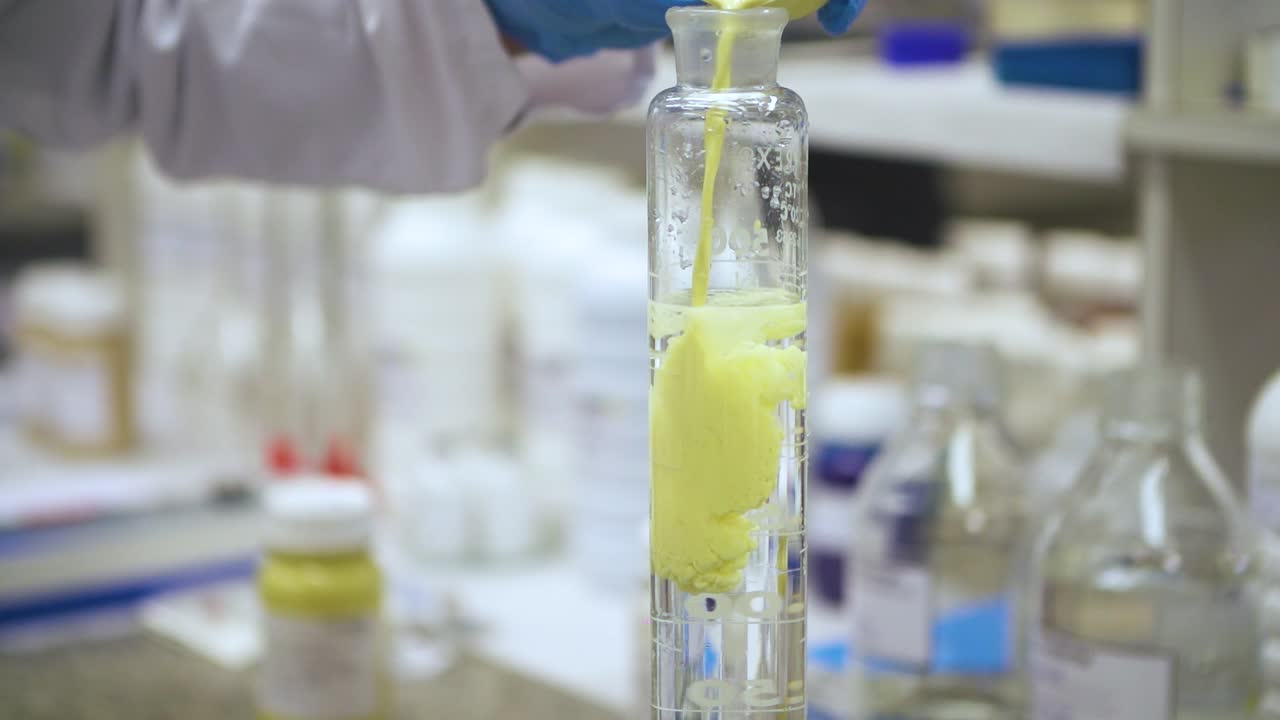 Lab Worker Doing Chemical Experiment In Laboratory in Slow Motion
