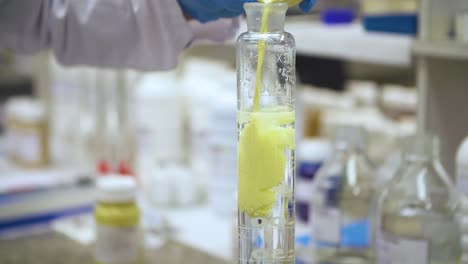 lab worker doing chemical experiment in laboratory in slow motion
