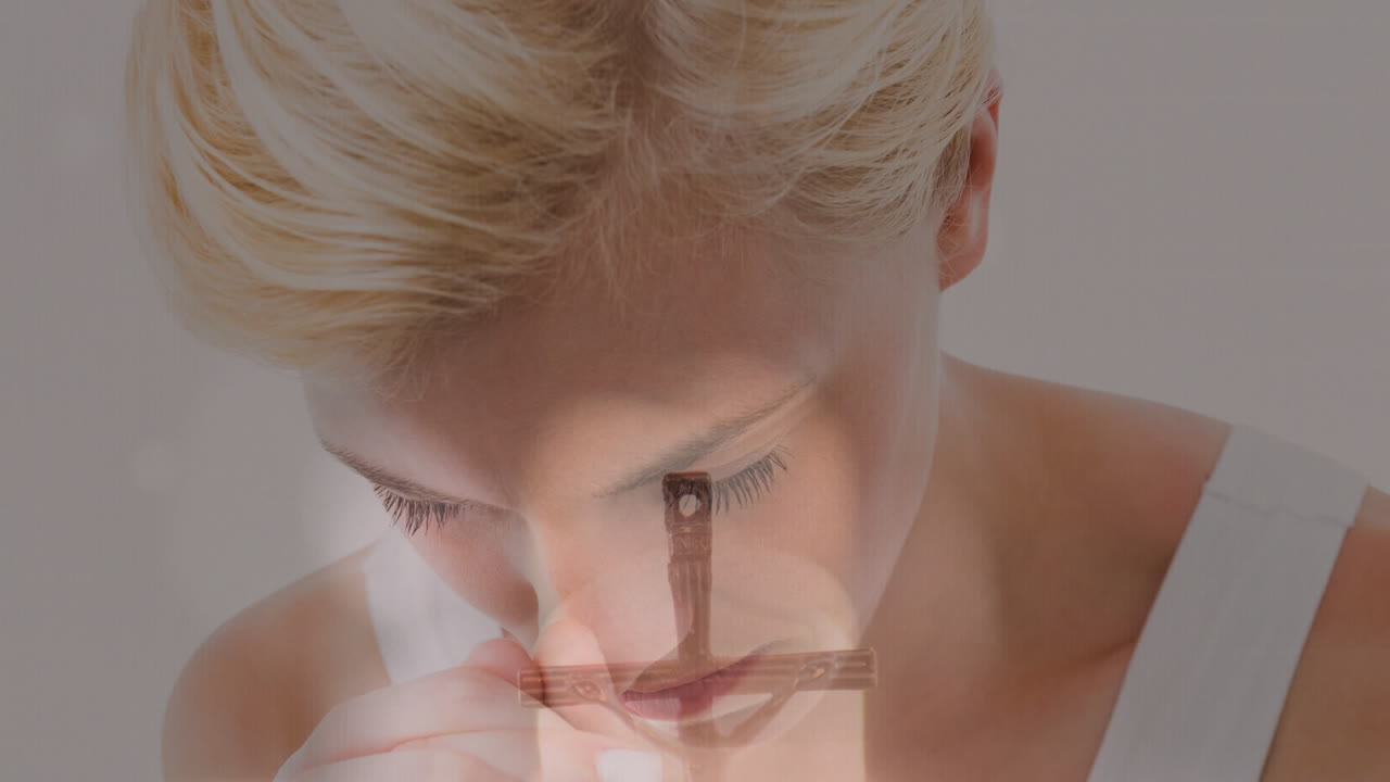 Praying woman with cross overlay on face, creating spiritual animation effect