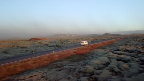 flying over a dirt road at sunset in iceland