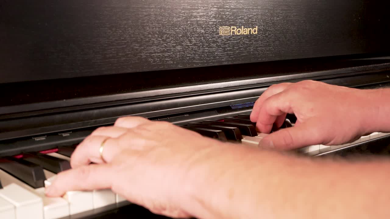 Man Playing a Roland Digital Piano