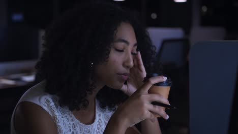 businesswoman working in a modern office by night