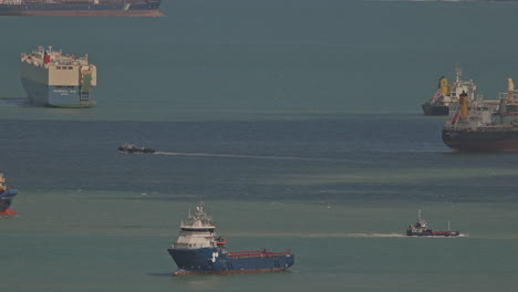 singapore - 5 march 2025 : container ships waiting in the sea by singapore