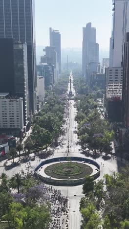 Aerial-view-of-8th-of-March-feminist-march-along-Paseo-de-la-Reforma,-vertical-screen