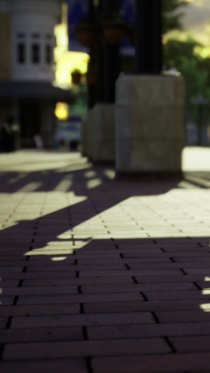 Shadows cast on a sidewalk during evening time in an urban area