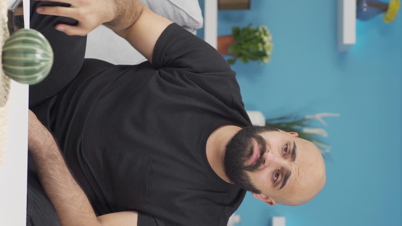 Vertical video of The grieving man is thinking and suffering from depression.