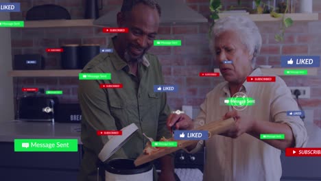 Animation-Von-Social-Media-Symbolen-über-Einem-Afroamerikanischen-Seniorenpaar,-Das-Zu-Hause-Gemeinsam-Kocht