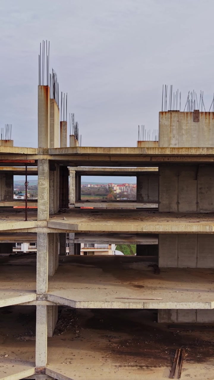 Construction site of a partially built concrete structure in an aerial view