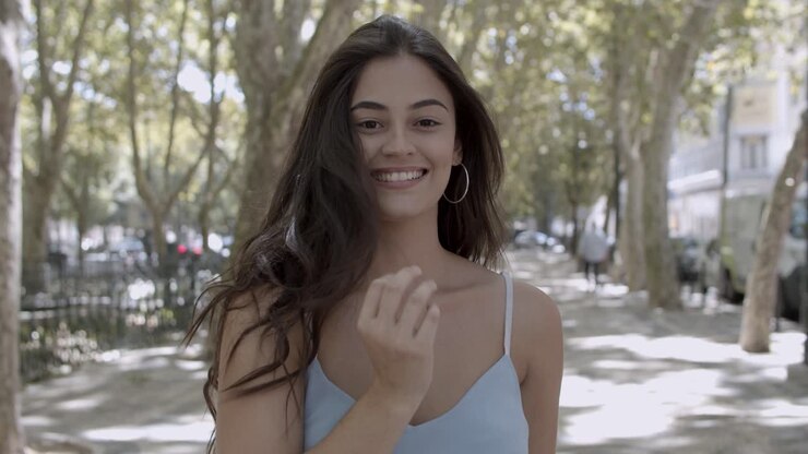 Portrait of young brunette woman standing on street