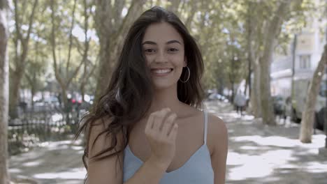 portrait of young brunette woman standing on street