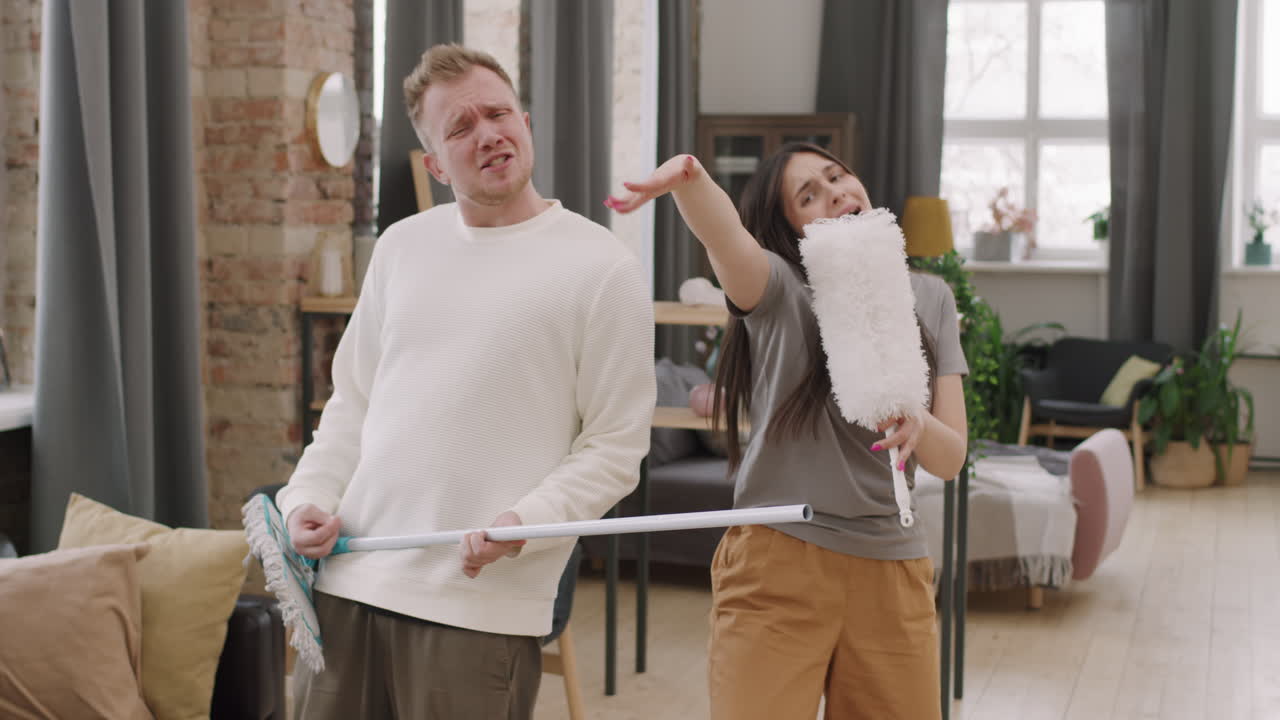 Young Couple Having Fun and Singing before Camera