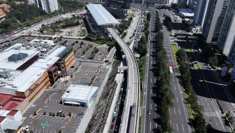 aerial view of city with highway traffic and train