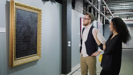 couple viewing abstract painting in an art gallery