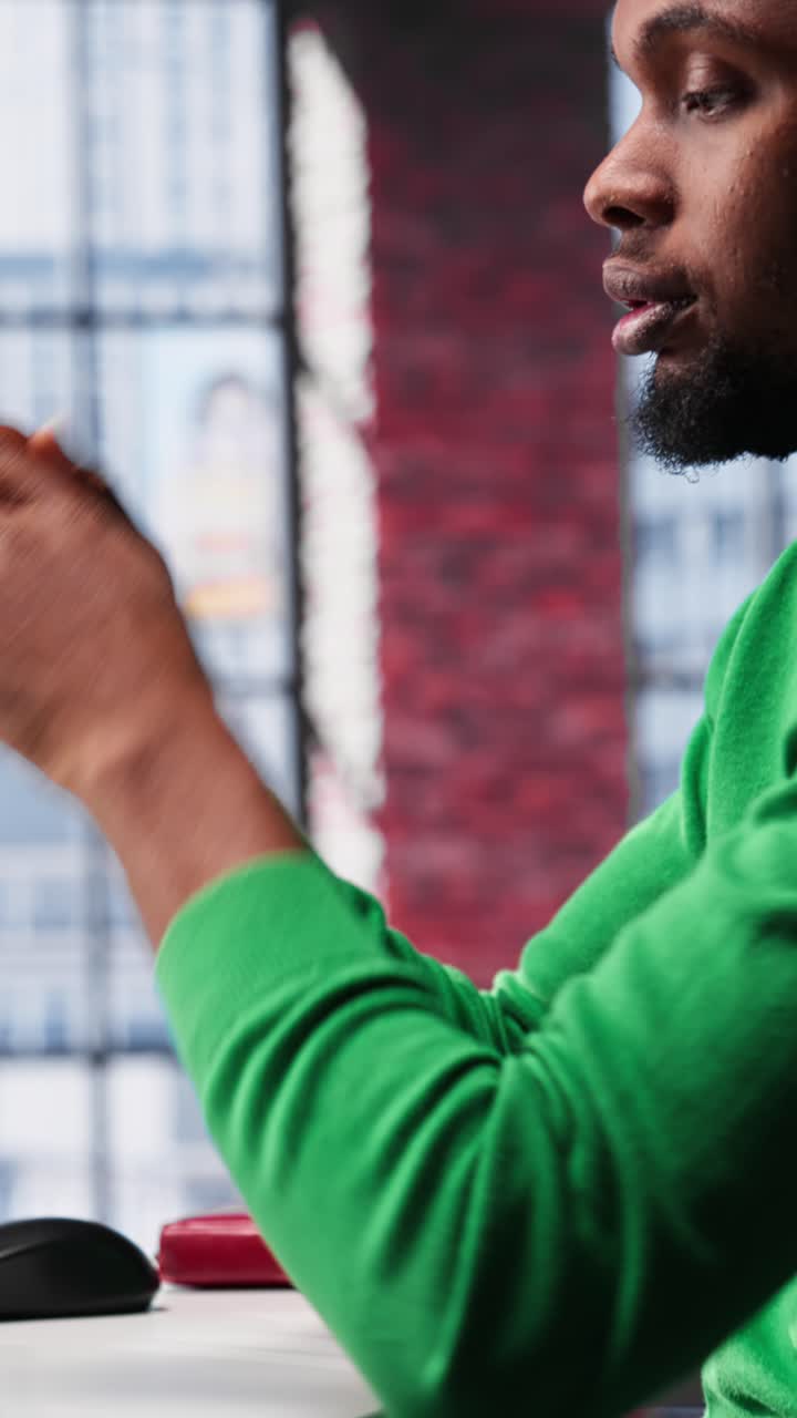 Vertical Video Man feeling exhausted and in pain from lack of sleep at home desk