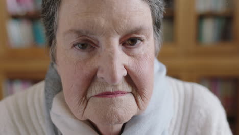 close-up-portrait-of-elderly-caucasian-woman-removing-glasses-looking-at-camera-library-background