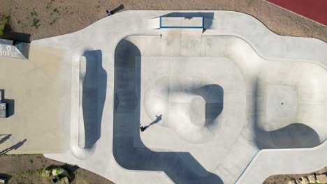 teenagers skateboarding at outdoor skate park